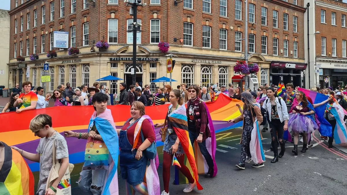 Parade holding rainbow flags down Friar Street
